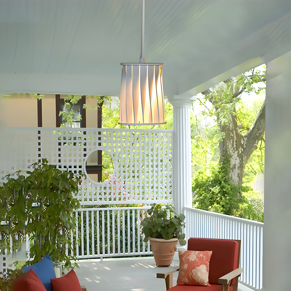 Contemporary patio space featuring hanging slat-style light fixtures above seating area