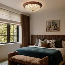 Decorative flush mount ceiling light in a warm modern bedroom with a large window
