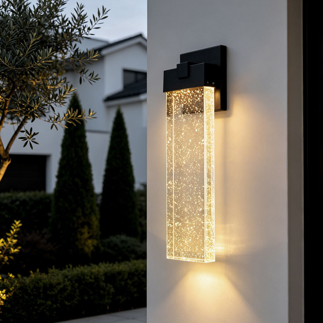tall seeded crystal outdoor wall light beside a modern entrance