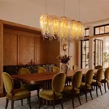 Modern glass chandelier above a long wooden dining table in an elegant dining room
