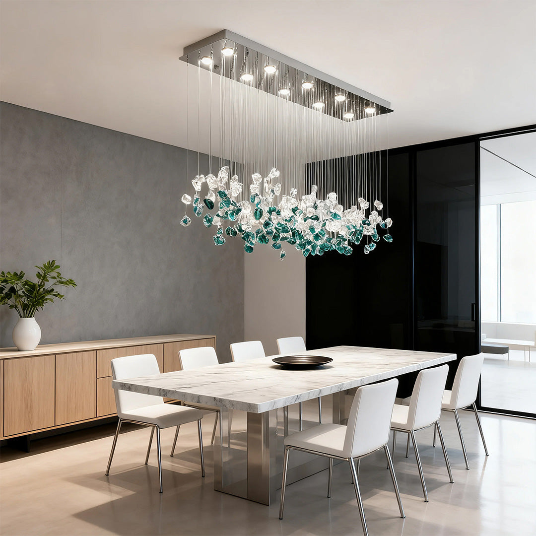 green and clear beaded glass chandelier above a long dining table