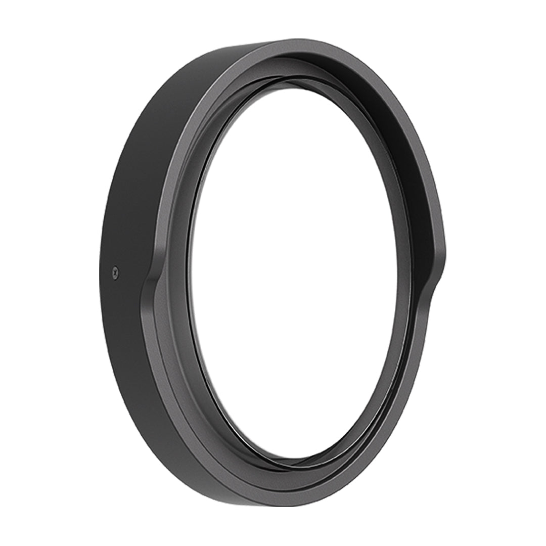 Round outdoor wall sconce with frosted diffuser creating ambient lighting on building exterior