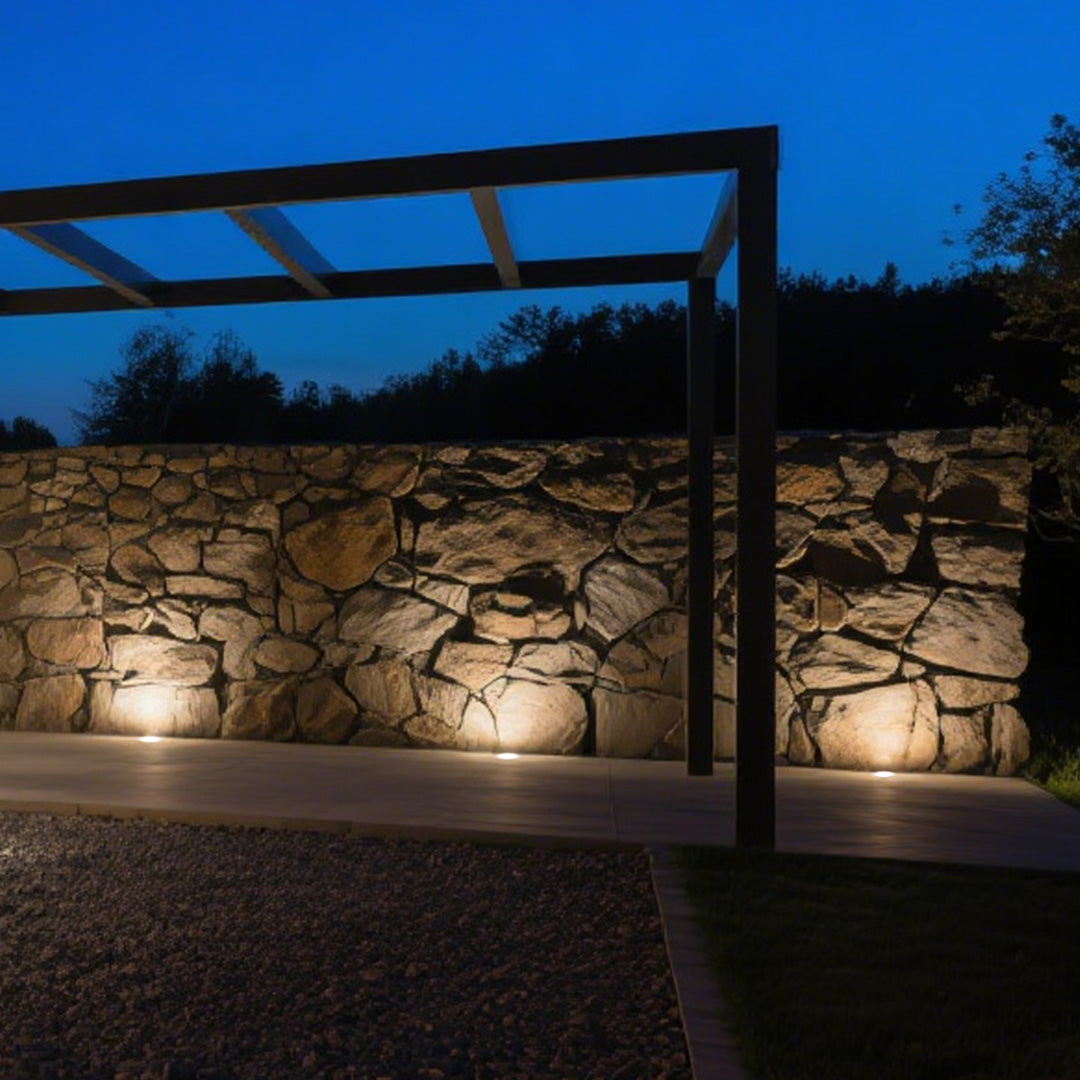 Black cylindrical ground light housing with cutout design for recessed landscape lighting installation