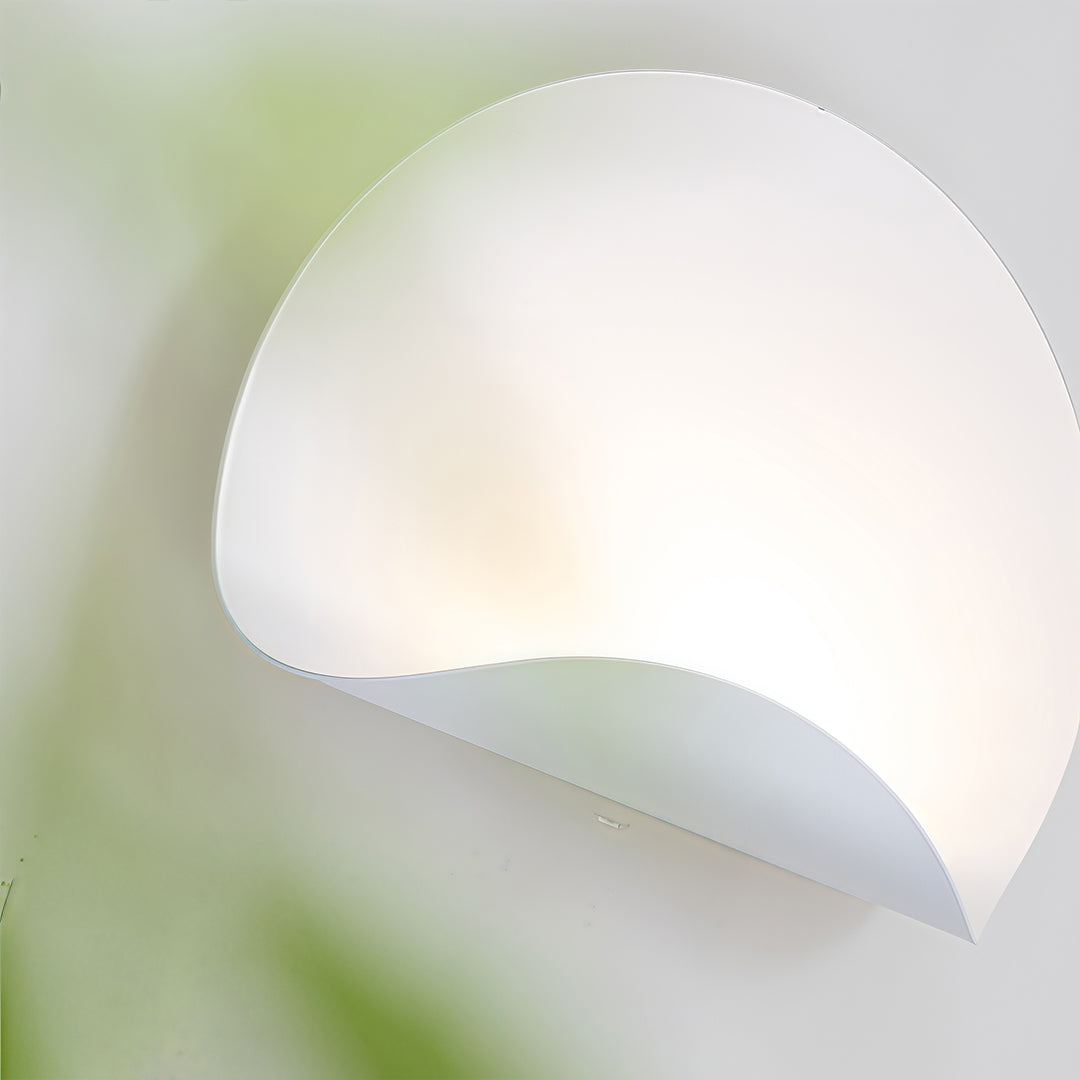 Abstract, soft-focus view of the white wall lights fixture, emphasizing the gentle curve and diffused light effect.