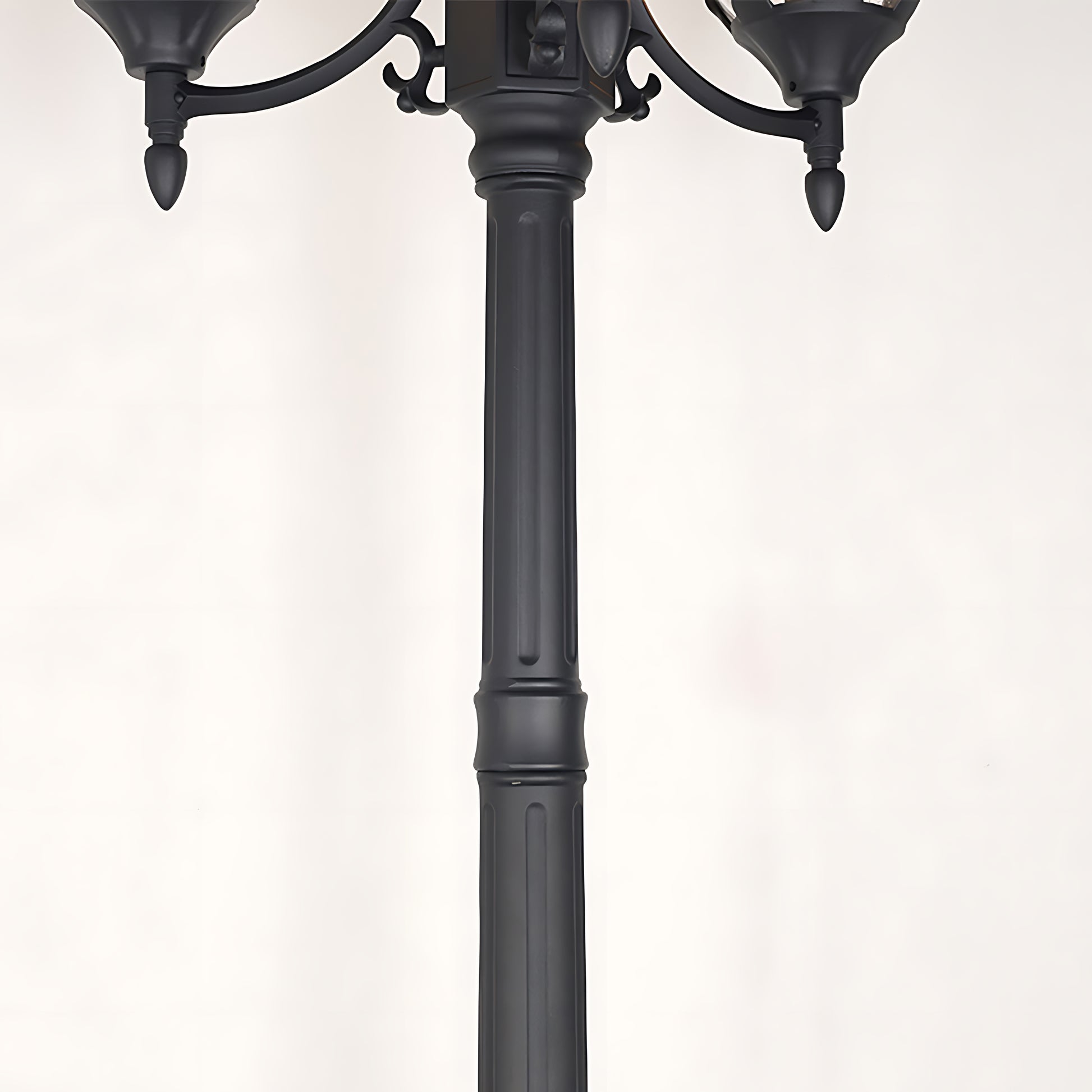 Detailed view of lamppost base and decorative metalwork junction showing craftsmanship