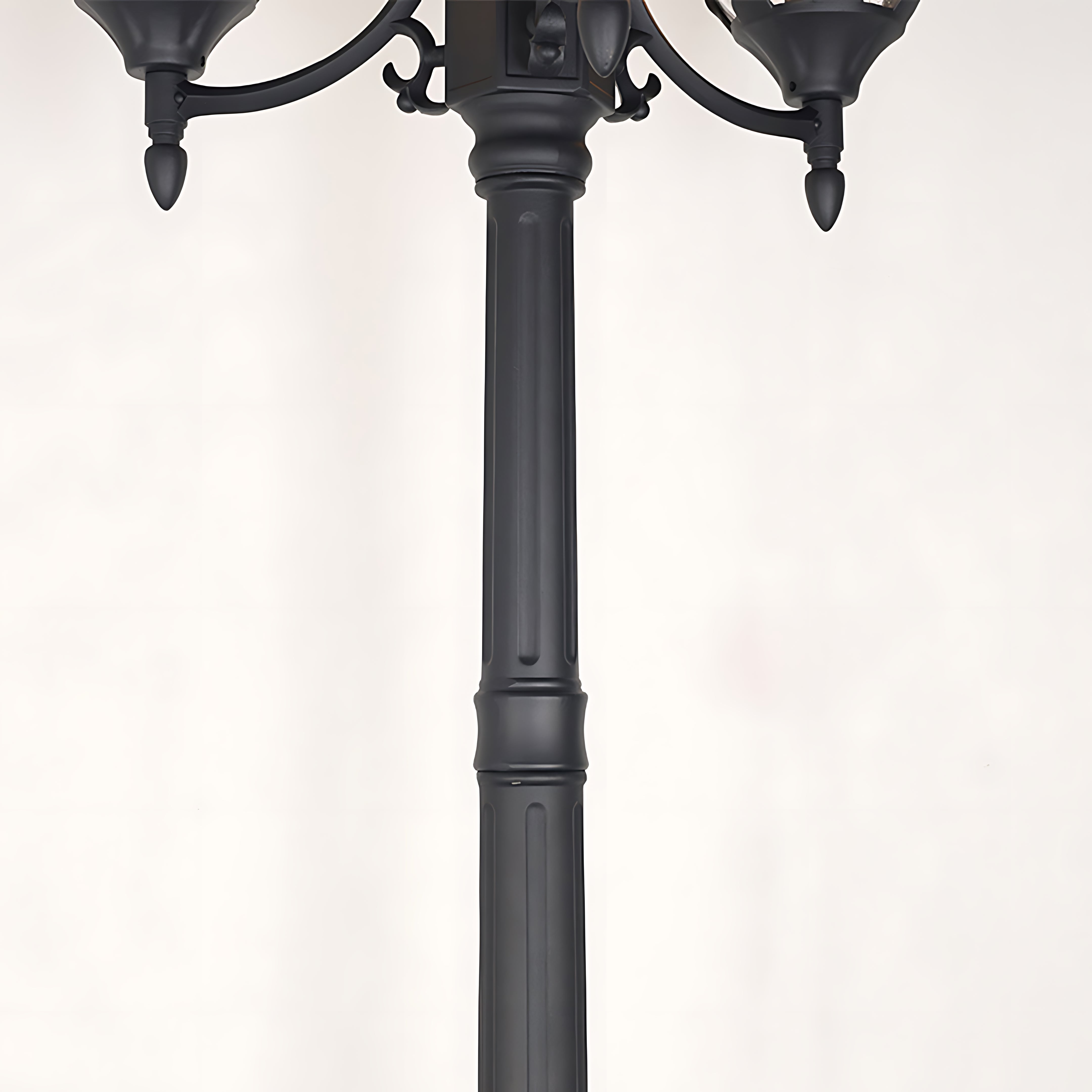 Detailed view of lamppost base and decorative metalwork junction showing craftsmanship