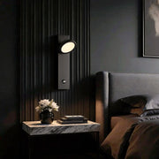 Accent wall lamp mounted beside bed creating focused ambient lighting.