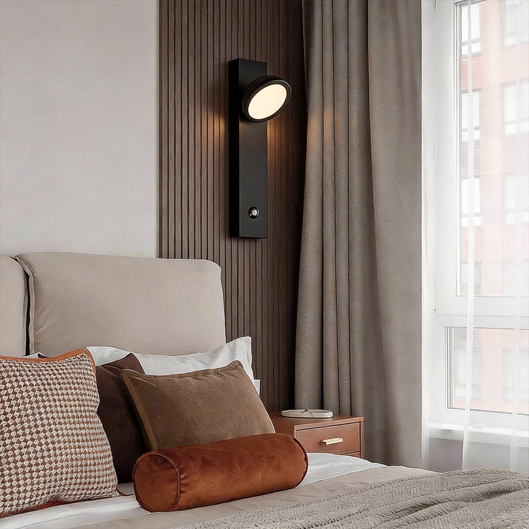 Accent wall lamp used as bedside reading light in modern bedroom.