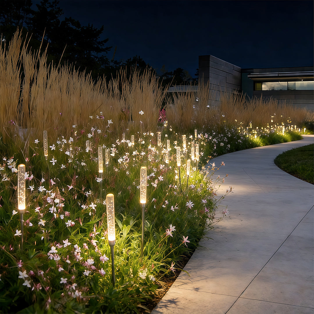 Acrylic bubble landscape light illuminating a modern garden pathway with warm ambient glow.