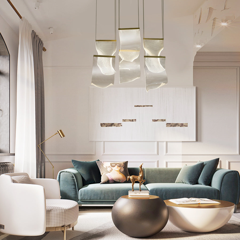Acrylic chandeliers providing ambient lighting in a modern staircase area.