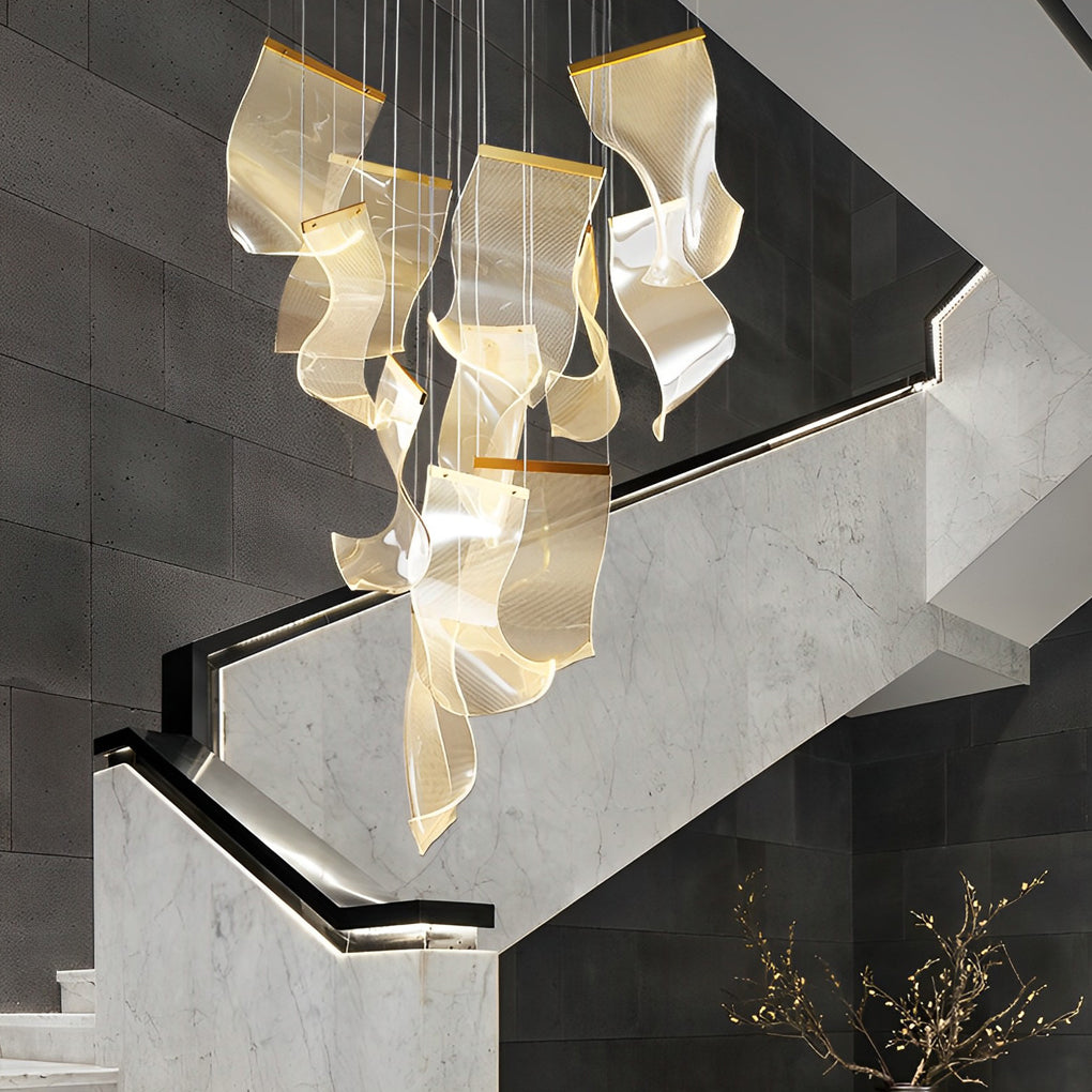Acrylic chandeliers with a gold finish, enhancing a contemporary interior.