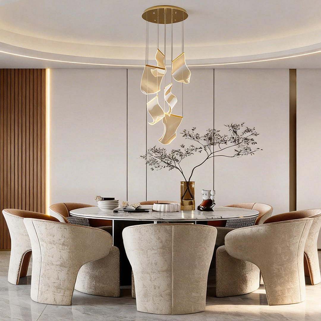 Acrylic chandeliers with a modern design, hanging above a luxurious dining table.