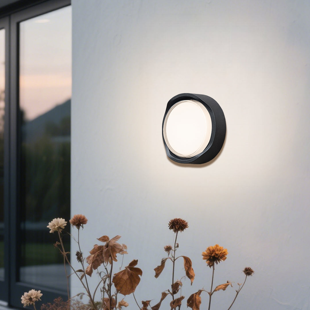 Modern black circular wall light with white LED panel for contemporary interior applications