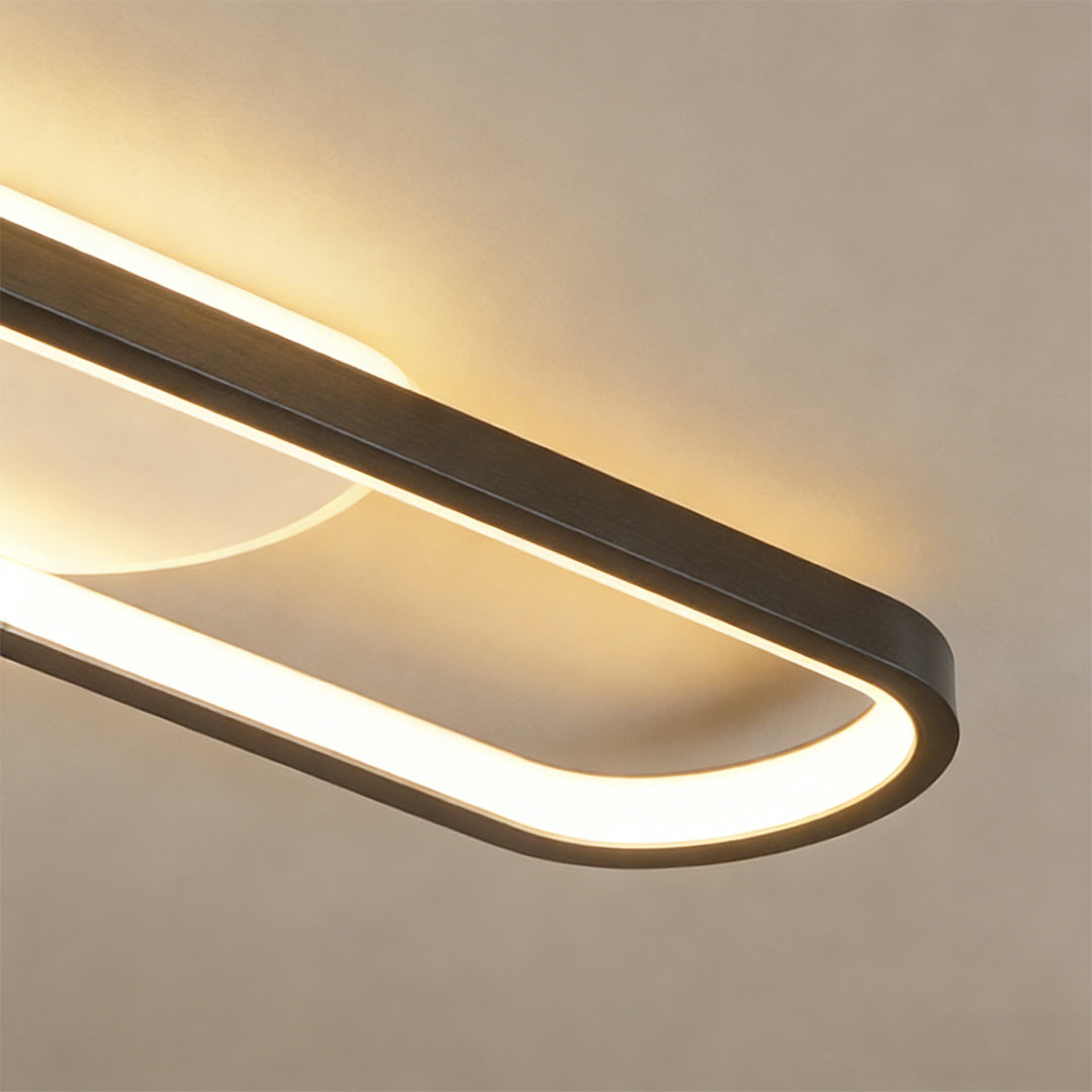 Close-up of adjustable ceiling spotlight with curved LED light design.
