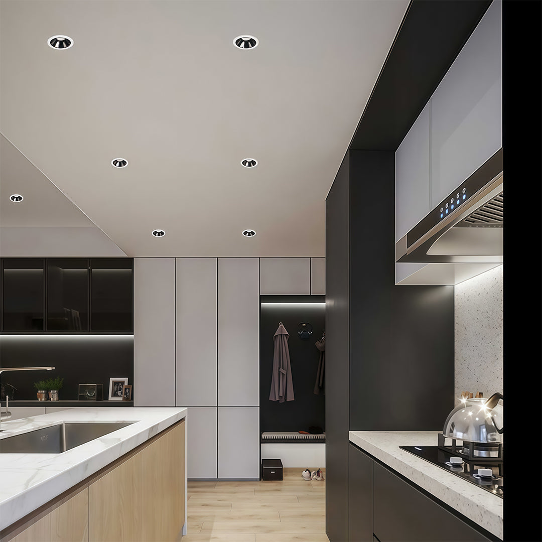 Adjustable downlights brightening contemporary living space with black architectural elements and white walls