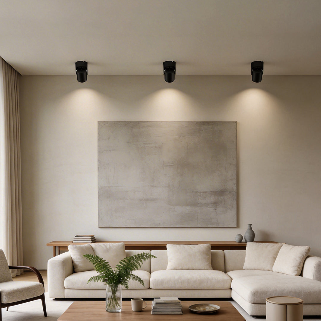 Adjustable downlights providing focused illumination in a contemporary bedroom.