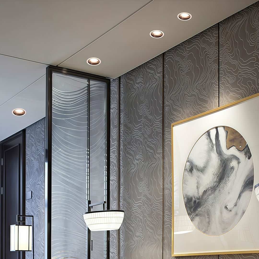 Adjustable downlights enhancing modern space with textured wall and white horse artwork
