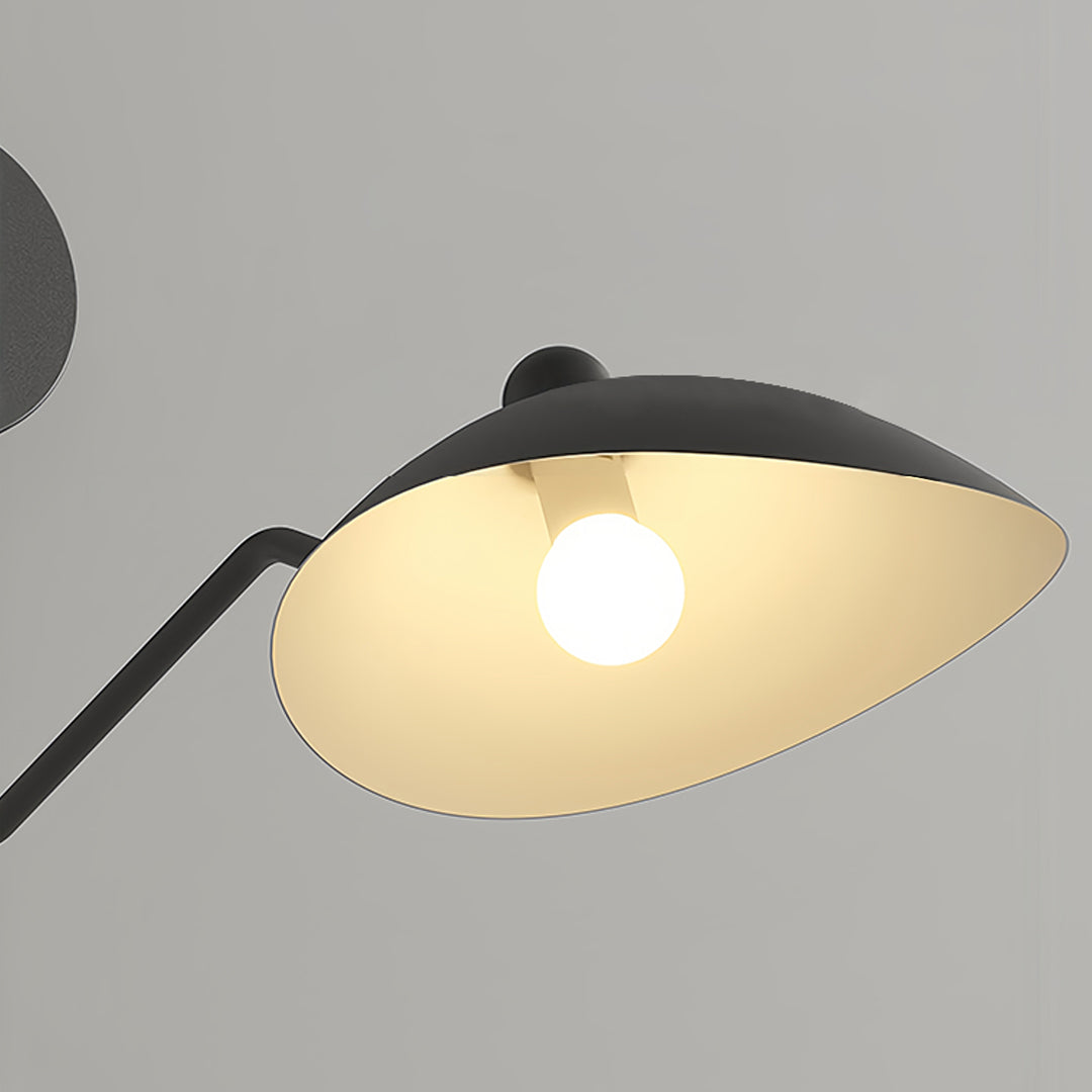 Adjustable swing arm wall light extending from a subtle wall mount, providing flexible lighting in a modern hallway or apartment space.