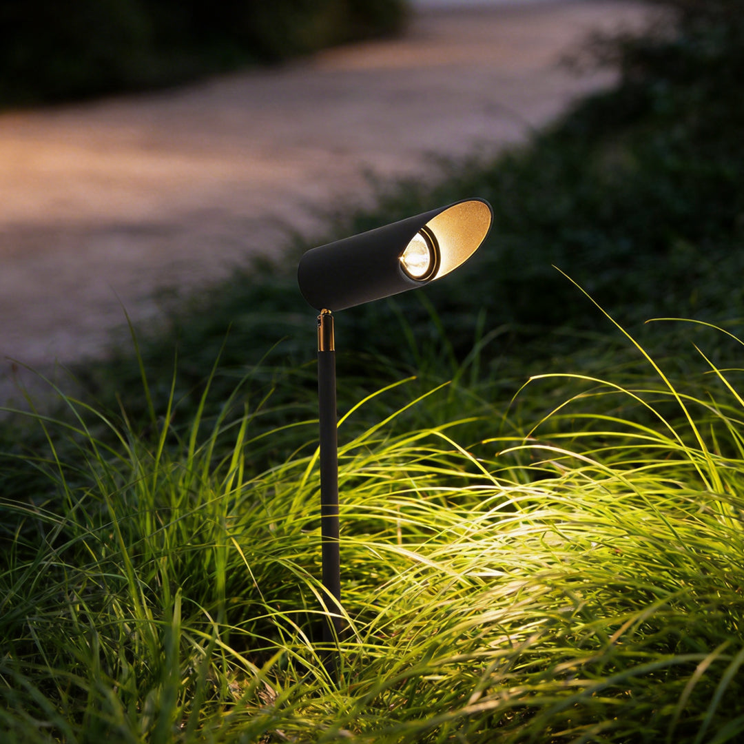 Adjustable landscape lighting illuminating a modern garden pathway with focused directional glow.