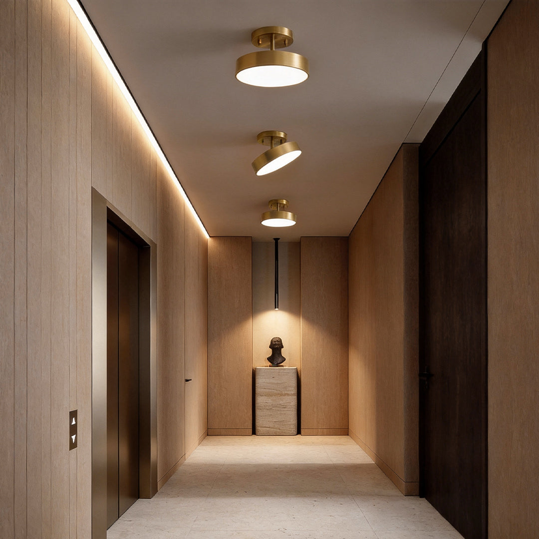 Adjustable LED ceiling lights installed in a modern hallway with warm ambient lighting.