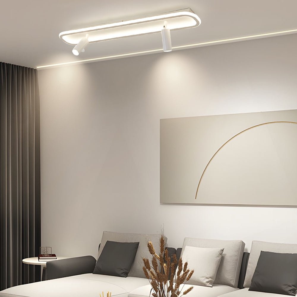 Modern adjustable LED ceiling spotlight featuring sleek design with a black finish, providing directed lighting in a minimalist room.