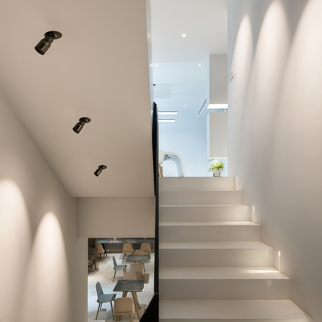 Adjustable LED downlight used in an art gallery setting, highlighting exhibits with precise and directional beam control.