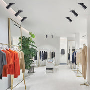 Adjustable LED downlights illuminating a clothing store interior, enhancing product displays with flexible lighting angles.