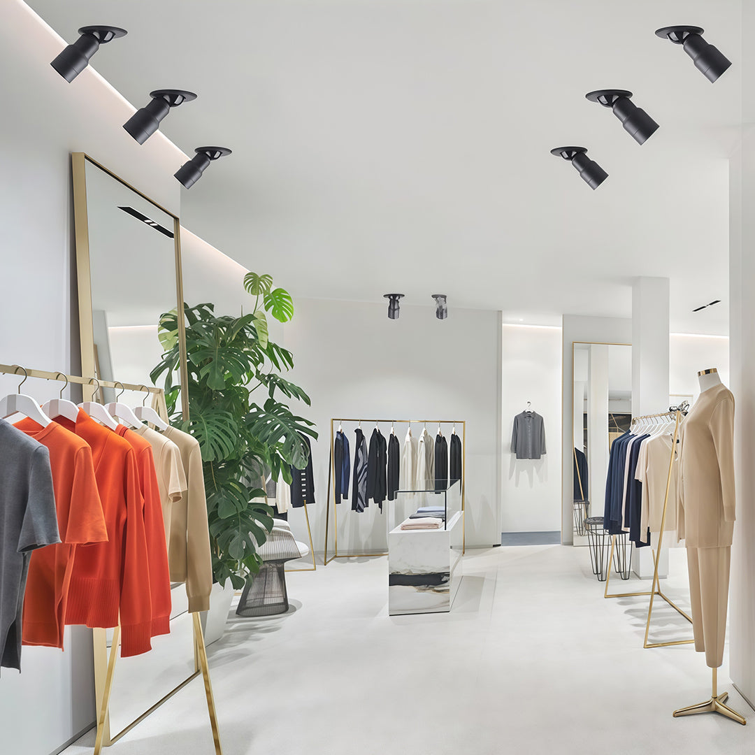 Adjustable LED downlights illuminating a clothing store interior, enhancing product displays with flexible lighting angles.