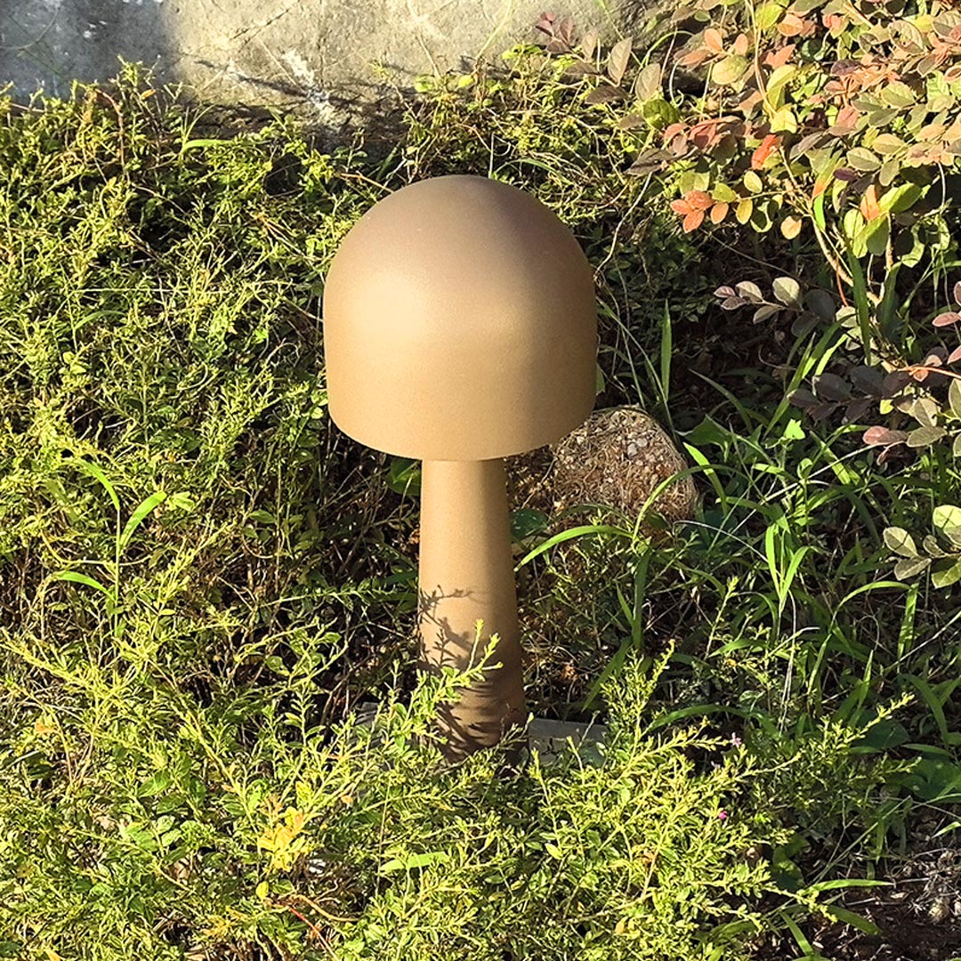 Modern adjustable LED landscape spotlight in a brushed nickel finish, aimed to highlight architectural features or trees