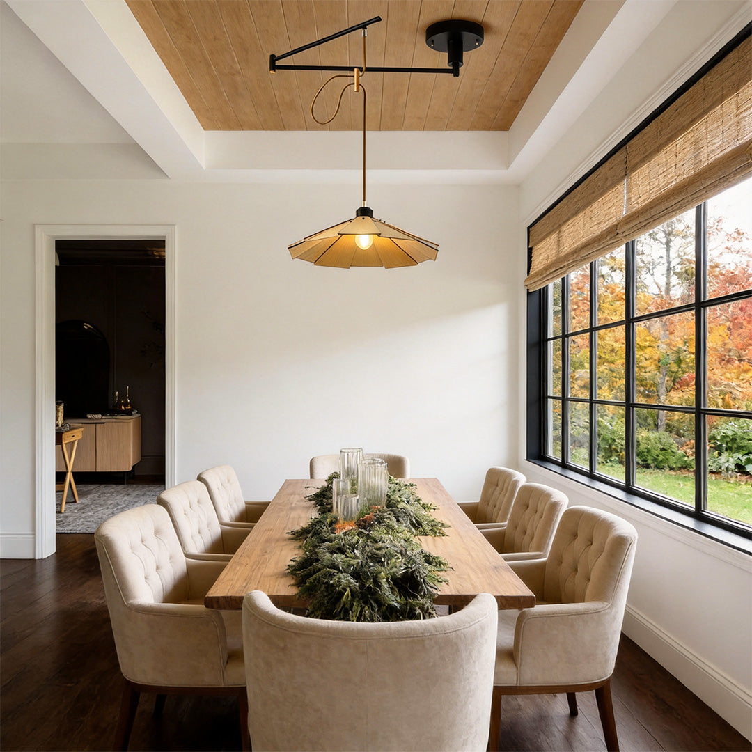 Adjustable pendant light fixture installed over a long dining table