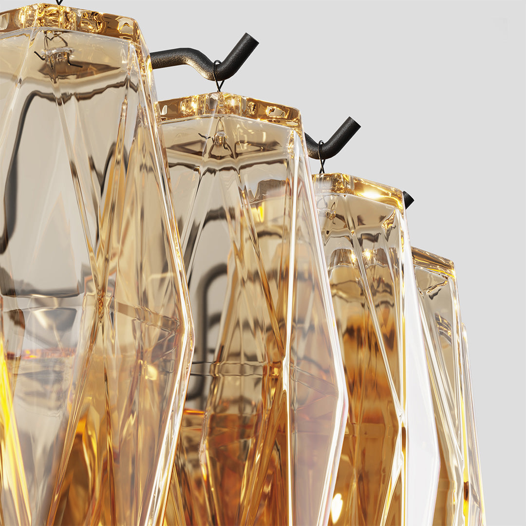 Close-up of amber crystal detail on a gold glass pendant chandelier showing fine craftsmanship.