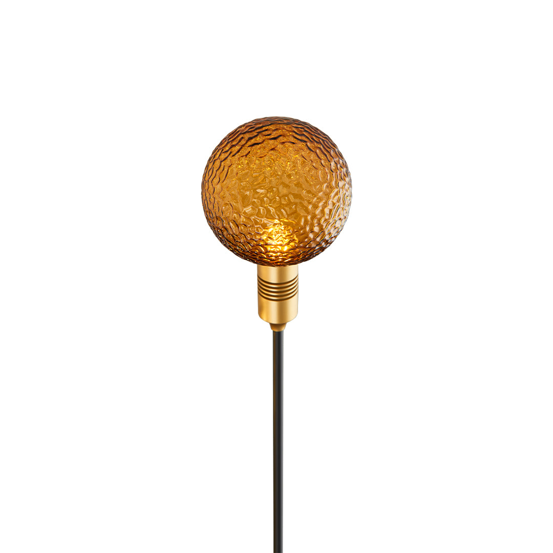 Amber-toned textured glass globe on a tall stake, designed for elegant path landscape lighting.
