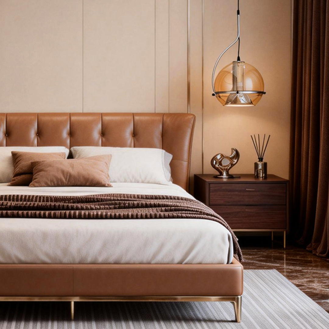 Amber glass globe pendant light hanging beside a bed, creating a cozy and elegant bedroom atmosphere.