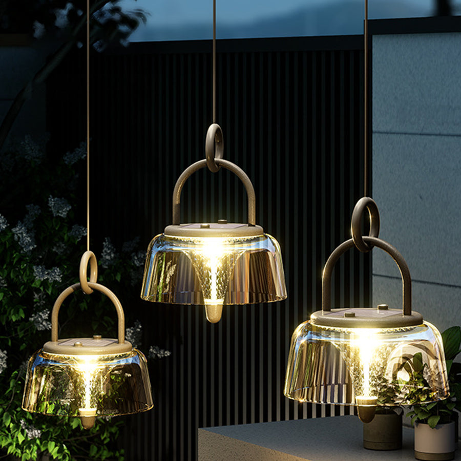 Collection of illuminated amber glass pendant lights creating warm atmospheric lighting in contemporary interior