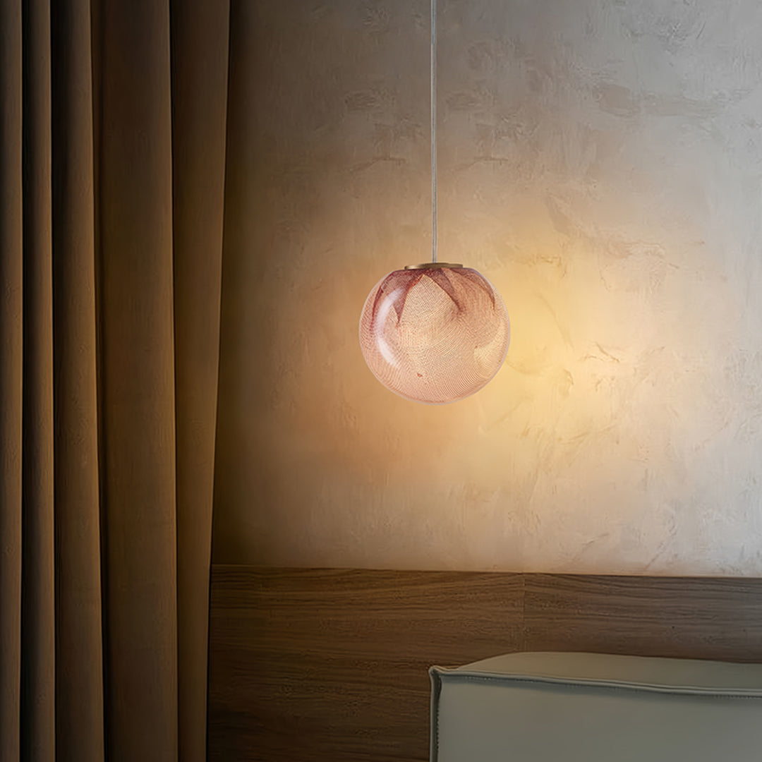 Sophisticated glass globe pendant lights featuring warm amber glass sphere creating cozy accent lighting in contemporary space