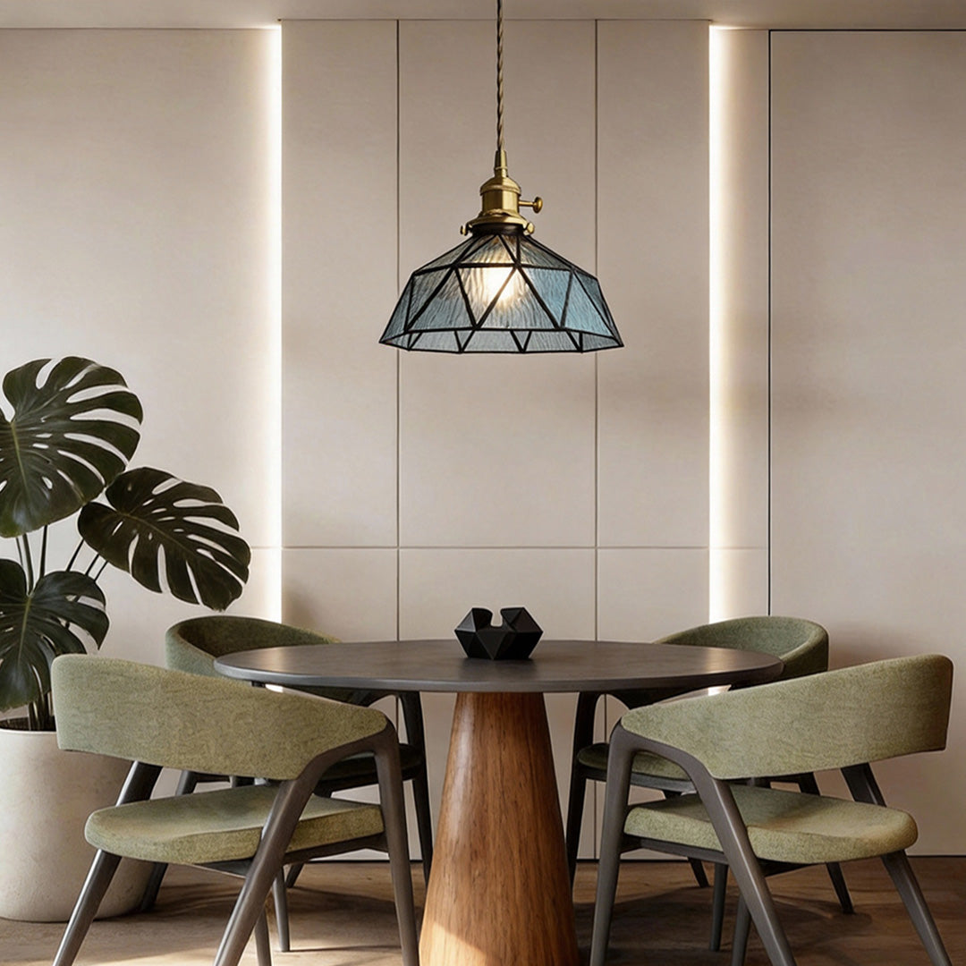 Amber indoor pendant light providing soft illumination above a contemporary dining table.