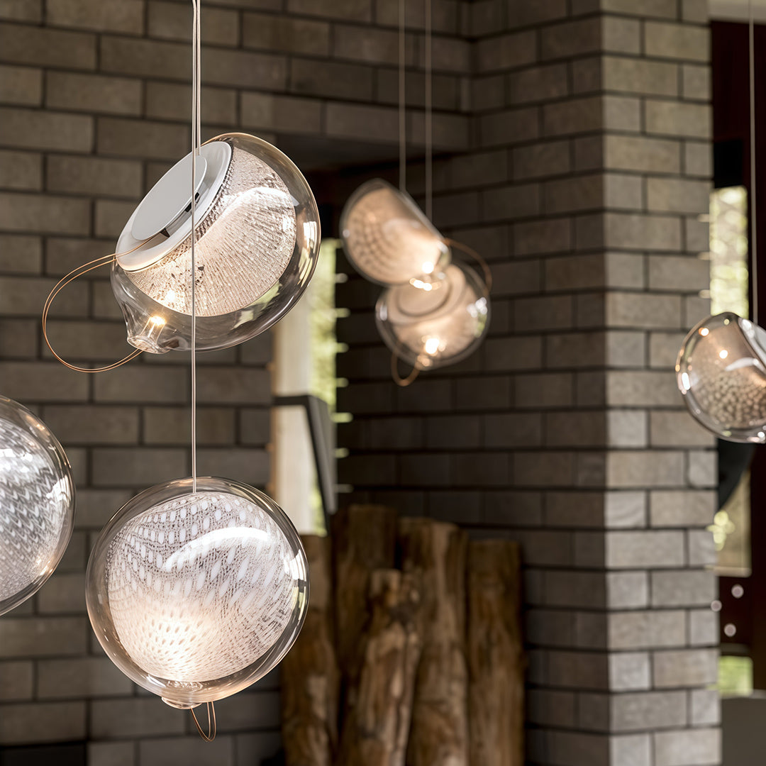 Amber-tinted jellyfish pendant light with artistic glass shade.