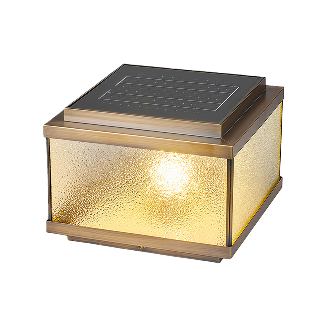 Square garden pillar light with warm amber glow and bubble-textured glass on dark solar panel top