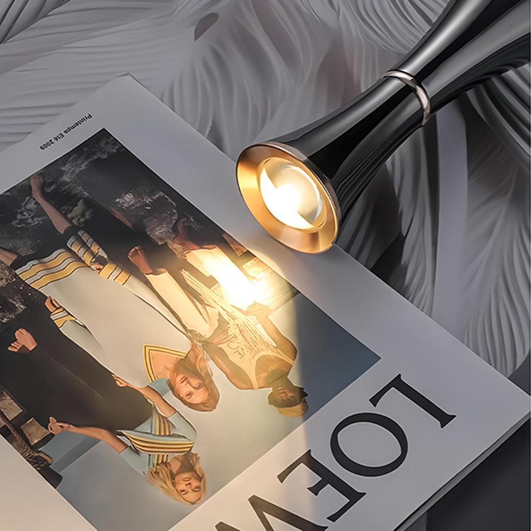 Small black pendant light creating warm ambient lighting in modern kitchen setting