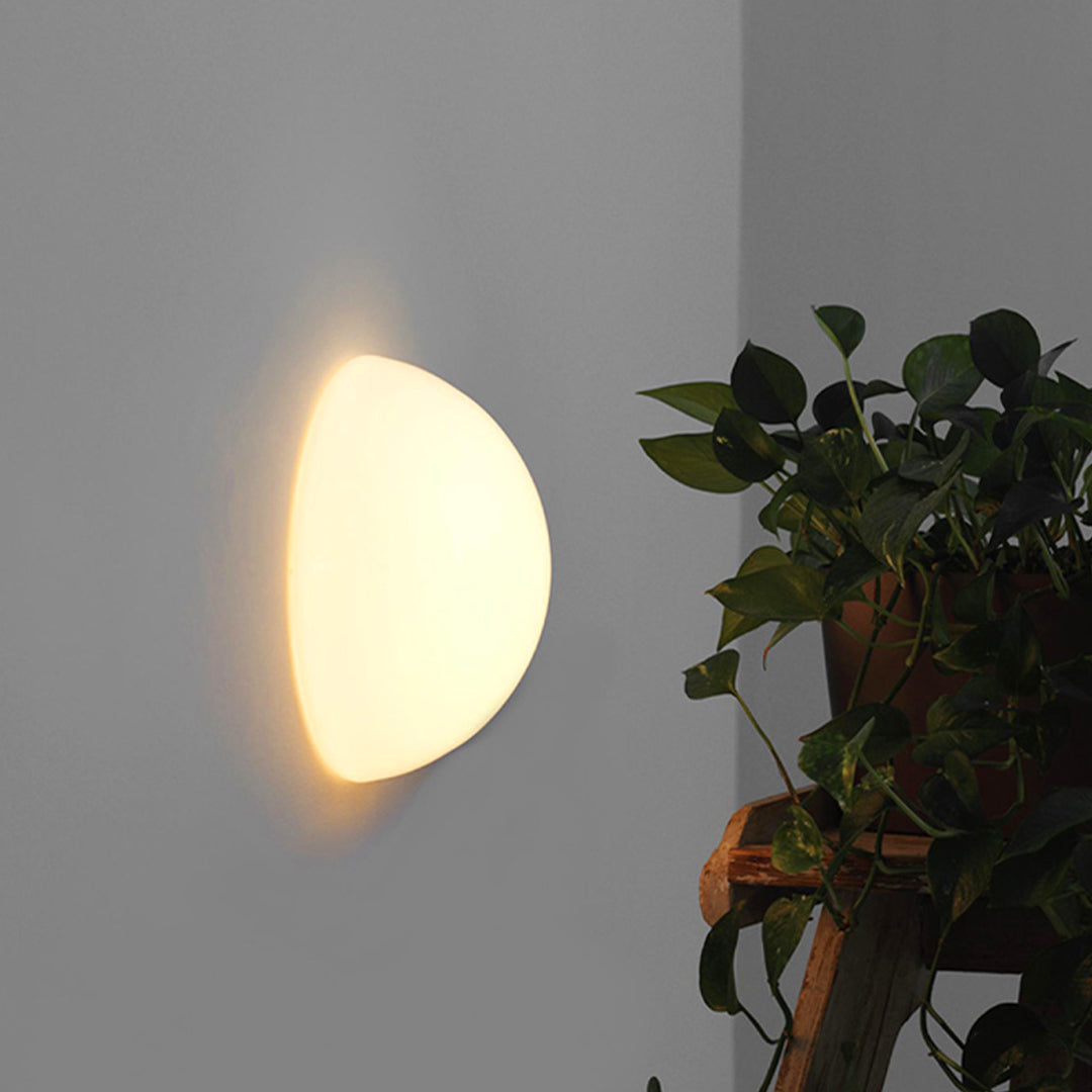 Ambient outdoor lighting wall mounted fixture highlighting indoor-outdoor transition space.