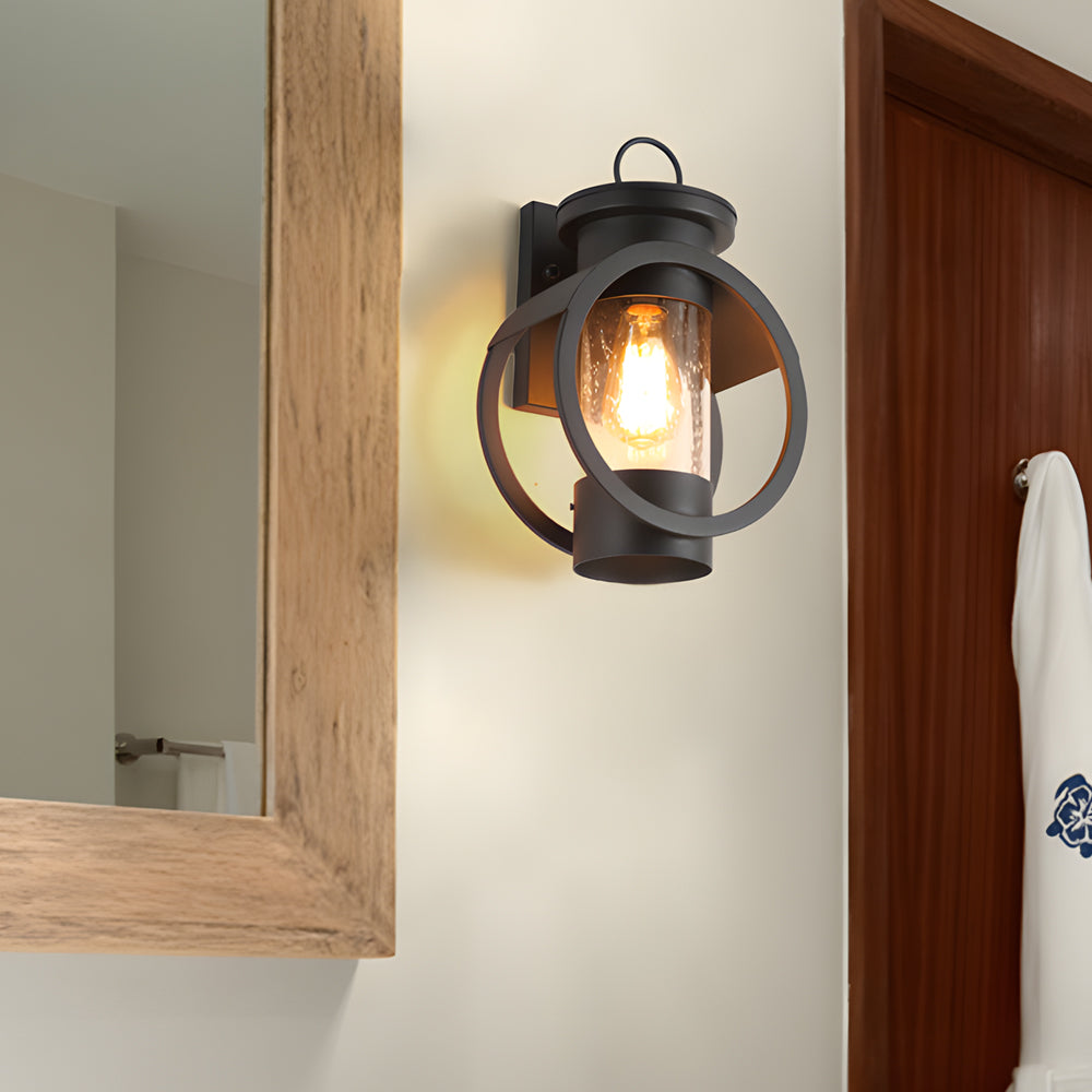 American style outdoor wall sconce mounted beside an entryway mirror