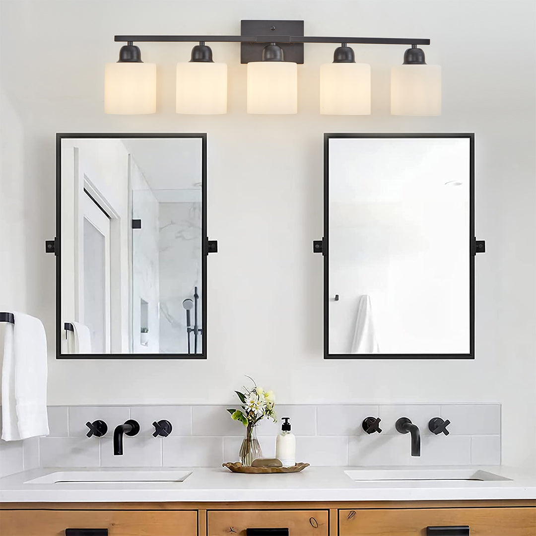 Modern bathroom vanity light with four bulbs, providing ample lighting above a bathroom mirror.