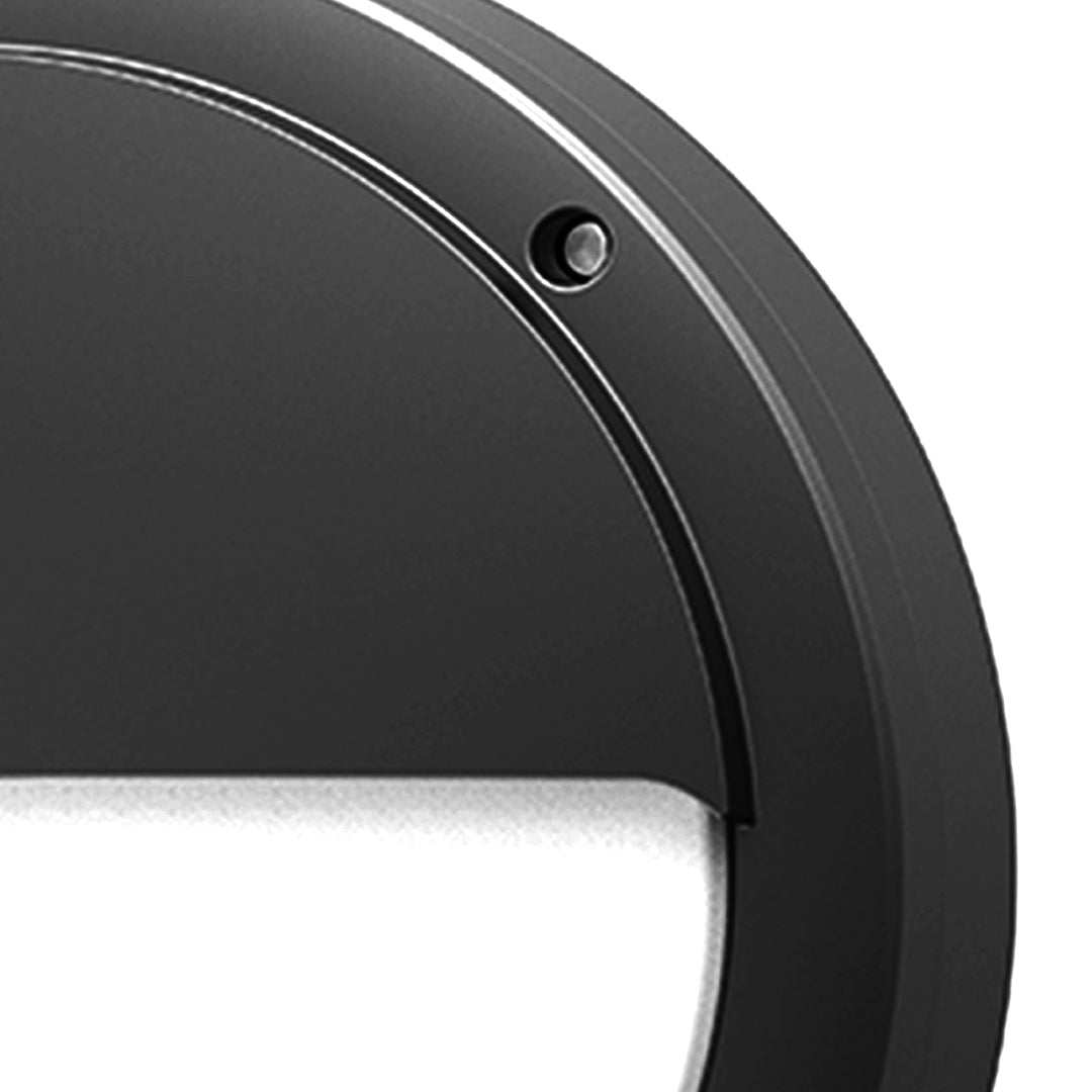Angled view of round outdoor wall sconce showing curved profile and mounting plate