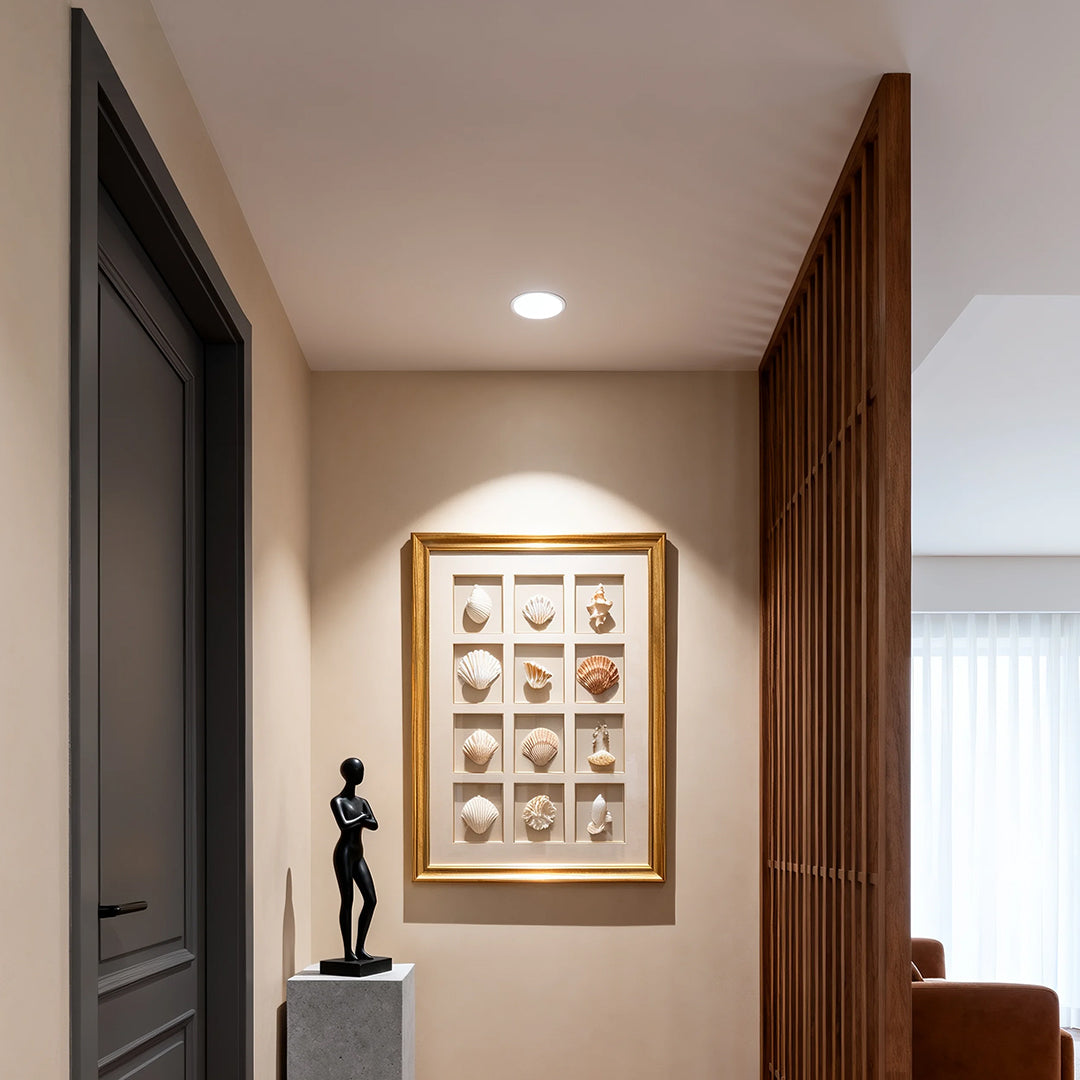 Anti glare downlight providing focused lighting in elegant corridor with framed art and warm wood