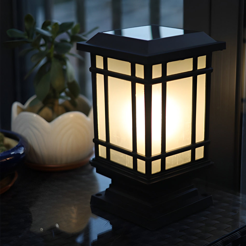Antique cast iron street light with a classic design, placed beside a decorative planter.