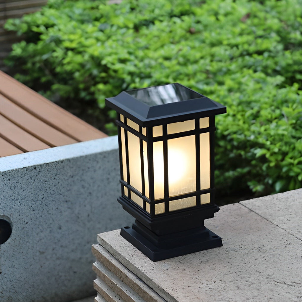 Antique cast iron street light providing soft illumination for a lush green garden.