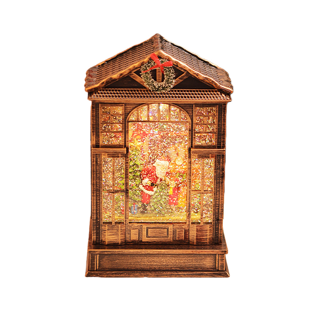 Classic bronze christmas decoration with light showcasing a detailed holiday scene behind frosted glass panels.