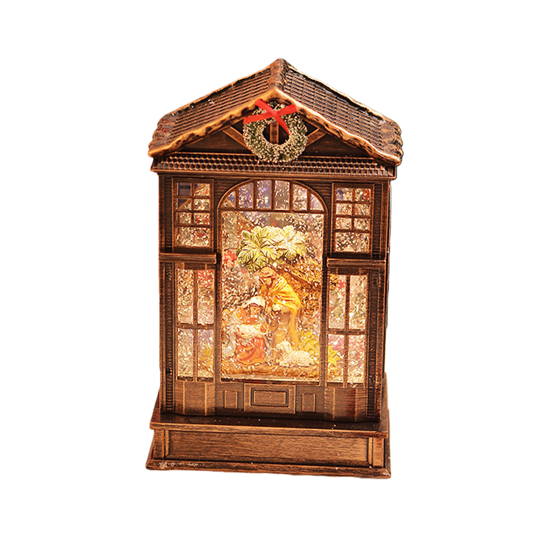 Classic bronze christmas decoration with light showcasing a detailed holiday scene behind frosted glass panels.