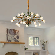 Antique vintage floral chandelier in elegant dining space with white flowers and refined interior styling