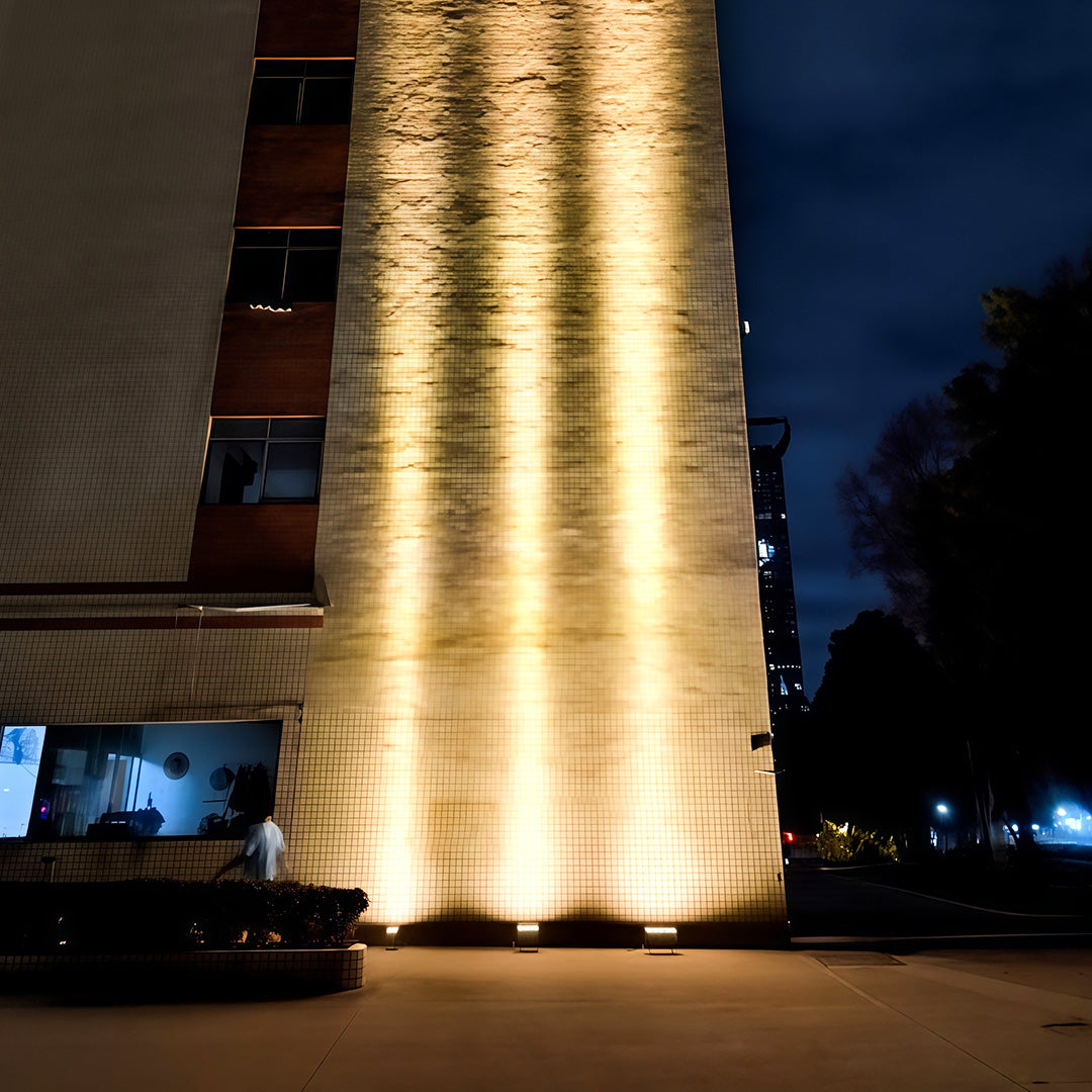 Apartment building facade lit by LED square wall wash light.